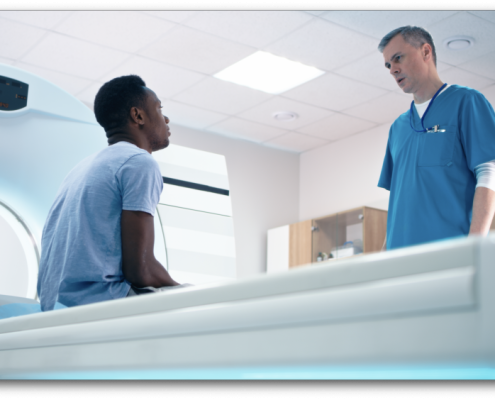Doctor standing over a male patient about to have an MRI for mens health